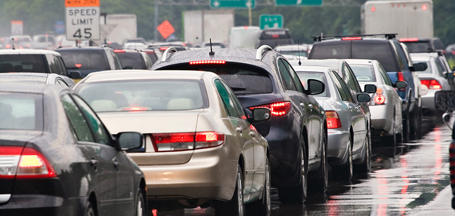 A typical scene during rush hour.  A traffic jam with rows of cars waiting to get off the next exit.