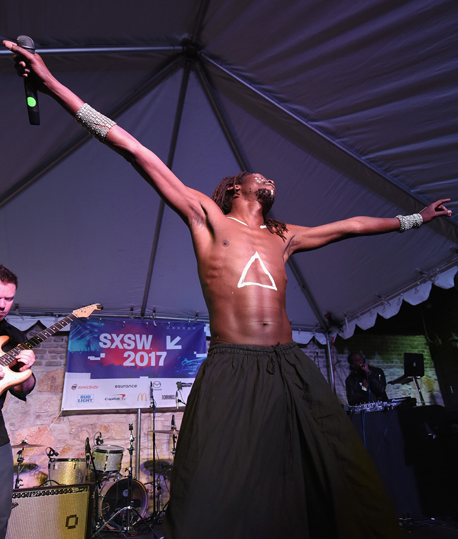 AUSTIN, TX - MARCH 17: Emmanuel Jal (C) performs onstage at ContraBanned #MusicUnites during 2017 SXSW Conference and Festivals at Palm Door on March 17, 2017 in Austin, Texas. (Photo by Katrina Barber/Getty Images for SXSW) AUSTIN, TX - MARCH 17: Emmanuel Jal (C) performs onstage at ContraBanned #MusicUnites during 2017 SXSW Conference and Festivals at Palm Door on March 17, 2017 in Austin, Texas. (Photo by Katrina Barber/Getty Images for SXSW)