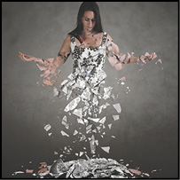 A woman shatters into hundreds of pieces of glass.